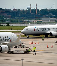 An American Eagle and American Airlines plane sits on the tarmac at Ronald Reagan Washington National Airport in Arlington, Virginia, on July 2. American and United airlines both reported their first operating profit since the start of the pandemic.
Mandatory Credit:	Stefani Reynolds/AFP/Getty Images