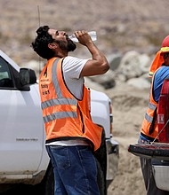 A construction worker drinks water in temperatures that have reached well above triple digits in Palm Springs, California, on June 20.  More than 85% of Americans are bracing for temperatures above 90 degrees Fahrenheit through the weekend.
Mandatory Credit:	David Swanson/Reuters