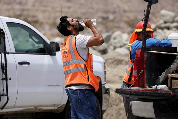 A construction worker drinks water in temperatures that have reached well above triple digits in Palm Springs, California, on June 20.  More than 85% of Americans are bracing for temperatures above 90 degrees Fahrenheit through the weekend.
Mandatory Credit:	David Swanson/Reuters
