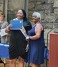 Sherrell Thompson, middle, shows off her certificate of graduation from Circles RVA last month.