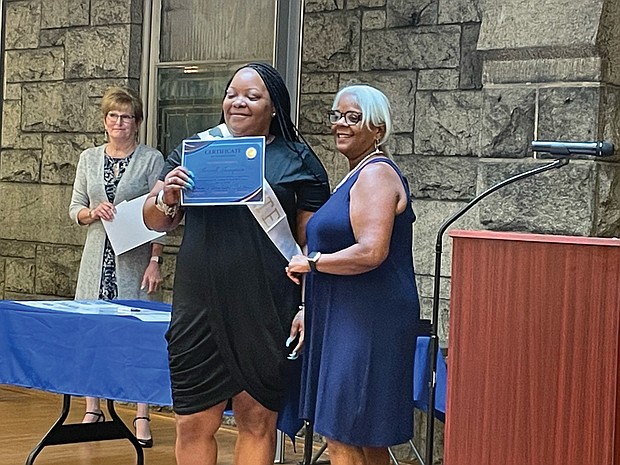 Sherrell Thompson, middle, shows off her certificate of graduation from Circles RVA last month.