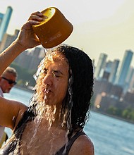 A woman pours water on her face in New York City as temperatures soared into the upper 90s on Sunday.
Mandatory Credit:	Alexi Rosenfeld/Getty Images