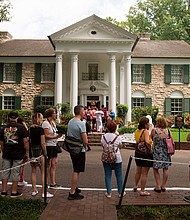 Fans wait in line outside Graceland, Elvis Presley's Memphis home, in Memphis, Tennessee, August 15, 2017.
Mandatory Credit:	Brandon Dill/Associated Press