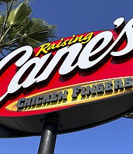 The founder of fast-food restaurant chain Raising Cane's bought 50,000 lottery tickets for employees.
Mandatory Credit:	Kirby Lee/AP