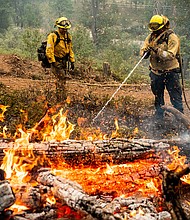 Firefighters mop up hot spots while battling California's Oak Fire.
Mandatory Credit:	Noah Berger/Associated Press