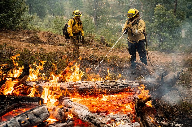 Firefighters mop up hot spots while battling California's Oak Fire.
Mandatory Credit:	Noah Berger/Associated Press