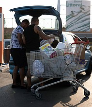 Customers load shopping into their vehicle in the parking lot of the Carrefour SA hypermarket in the Grand Littoral retail park in Marseille, France, on Monday, July 25, 2022. French retailer Carrefour reports half-year earnings on July 27.
Mandatory Credit:	 Jeremy Sukur/Bloomberg/Getty Images
