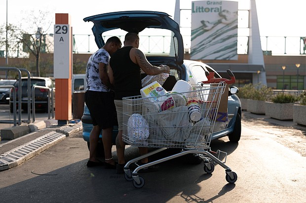 Customers load shopping into their vehicle in the parking lot of the Carrefour SA hypermarket in the Grand Littoral retail park in Marseille, France, on Monday, July 25, 2022. French retailer Carrefour reports half-year earnings on July 27.
Mandatory Credit:	 Jeremy Sukur/Bloomberg/Getty Images