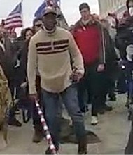 A frame taken from the body worn camera of a of MPD Officer shows Mark Ponder armed with a long pole with red, white, and blue stripes.
Mandatory Credit:	Dept. of Justice