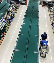 People shop at a supermarket in Arlington, Virginia, June 10, 2022.
Mandatory Credit:	Saul Loeb/AFP/Getty Images