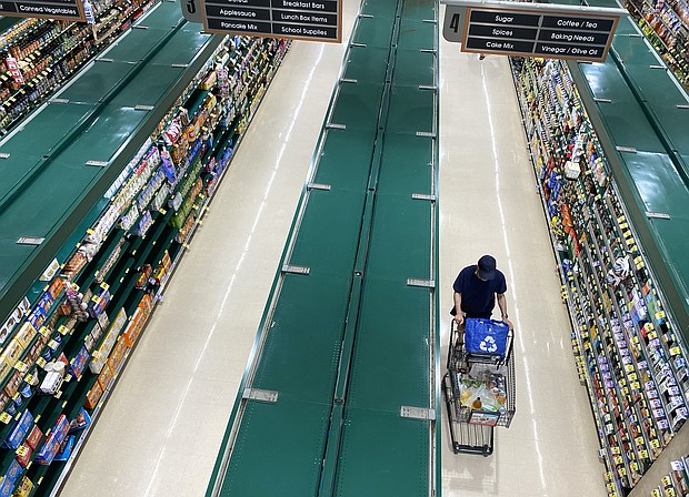 People shop at a supermarket in Arlington, Virginia, June 10, 2022.
Mandatory Credit:	Saul Loeb/AFP/Getty Images