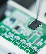 Semi automatic machine robot installing semiconductor chip on board.
Mandatory Credit:	Kadmy/Adobe Stock