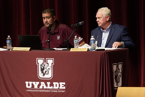 Dr. Hal Harrell, right, and Uvalde Consolidated Independent School District Board Trustee president Luis Fernandez, left, listen to comments from parents and residents during a special meeting to address concerns over last month's shootings at Robb Elementary School, Monday, July 18, 2022, in Uvalde, Texas.
Mandatory Credit:	Eric Gay/AP