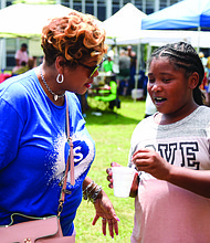 Dr. Shonda Harris-Muhammed, right, board chairwoman for Richmond Public Schools, chats with student.
