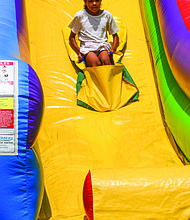 Olivia Beatty, 8, glides down a giant slide at the fun-filled RPS Summer Fest.