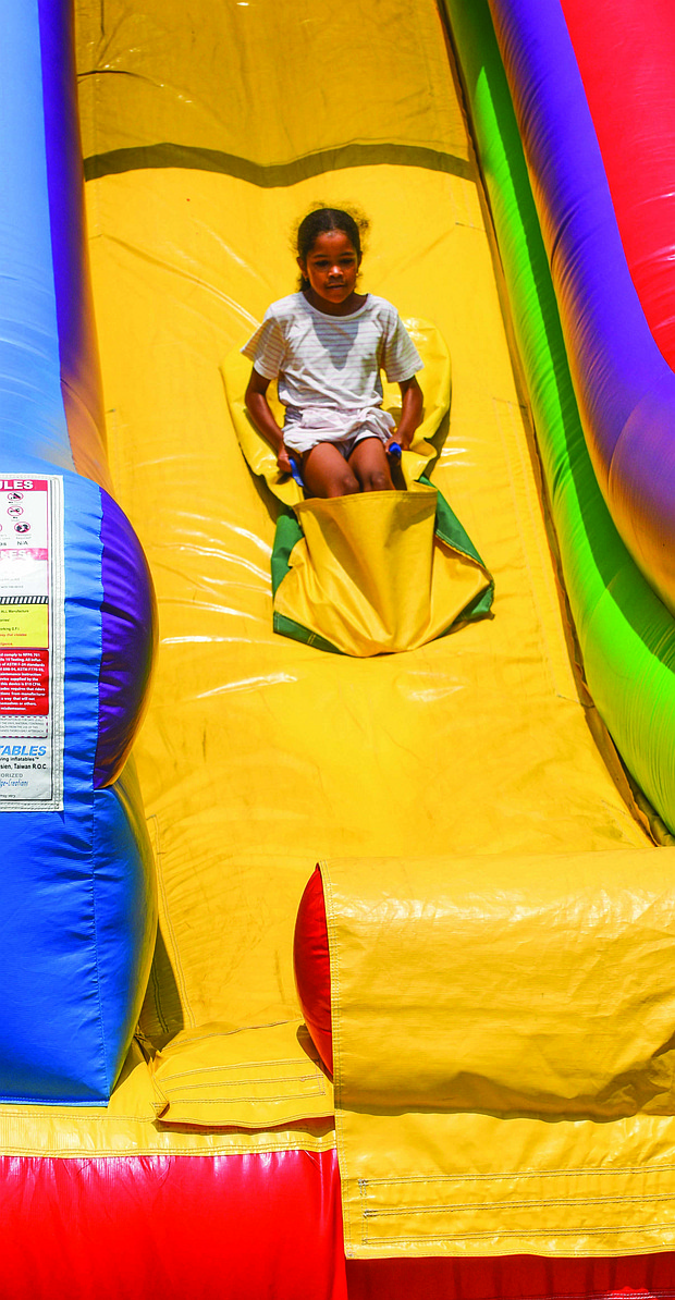 Olivia Beatty, 8, glides down a giant slide at the fun-filled RPS Summer Fest.