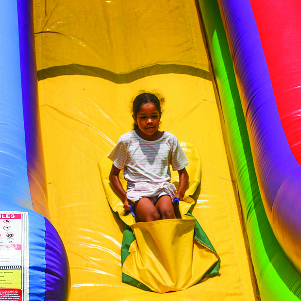 Olivia Beatty, 8, glides down a giant slide at the fun-filled RPS Summer Fest.