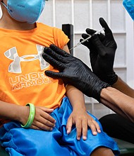 A 4-year-old receives a coronavirus disease (COVID-19) vaccine for children under five years old at Skippack Pharmacy in Schwenksville, Pennsylvania, U.S., June 21, 2022.
Mandatory Credit:	Hannah Beier/Reuters/FILE