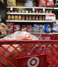 Discounts are back. A woman here shops at a Target store in New York City, July 21.
Mandatory Credit:	Anthony Behar/Sipa/AP