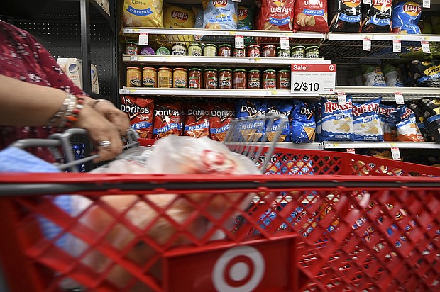 Discounts are back. A woman here shops at a Target store in New York City, July 21.
Mandatory Credit:	Anthony Behar/Sipa/AP