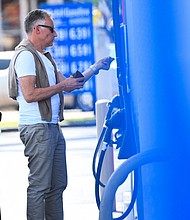A customer uses a credit card before they pump gas at a Mobil gas station on April 28, in Los Angeles, California.
Mandatory Credit:	Patrick T. Fallon/AFP/Getty Images