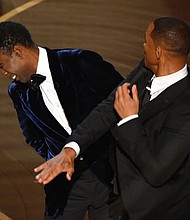 Will Smith and Chris Rock on stage at the Oscars.
Mandatory Credit:	Robyn Beck/AFP/Getty Images