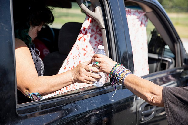 Maggy Johnston hands out water Tuesday in Salem, Oregon, where temperatures topped 100 degrees.
Mandatory Credit:	Brian Hayes/AP