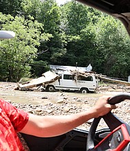 Resident Louis Turner carries water to friends and family along flood-ravaged Bowling Creek, Kentucky.
Mandatory Credit:	Chris Kenning/USA Today Network/Reuters