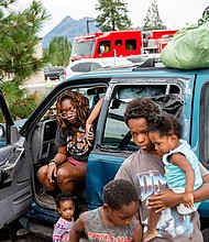 Paisley Bamberg and her family spend time outside a shelter for McKinney Fire evacuees in Weed, California on August 1.
Mandatory Credit:	Noah Berger/AP