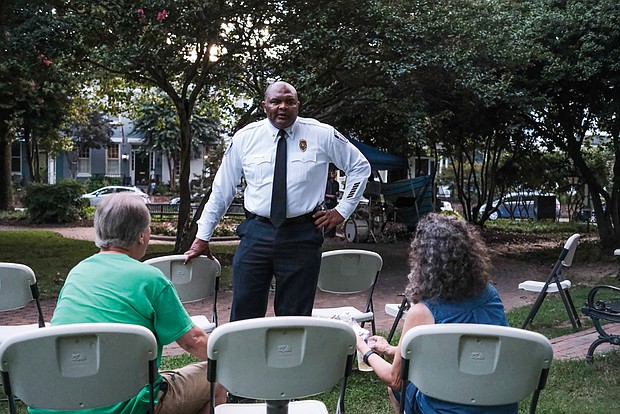 At Meadow Park in the Fan, Richmond Police Chief Gerald M. Smith chats with area residents Matt and Nancy Costello.