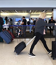 Travelers walk with their luggage at San Francisco International Airport on July 1 in San Francisco, California. The US Department of Transportation has proposed changes to allow airline passengers to seek refunds under circumstances including major delays and Covid-19.
Mandatory Credit:	Justin Sullivan/Getty Images