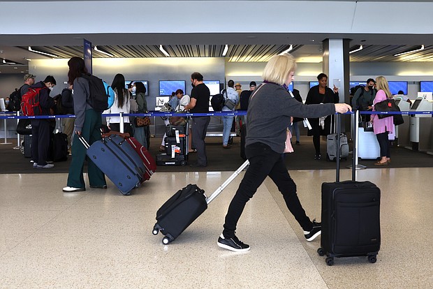 Travelers walk with their luggage at San Francisco International Airport on July 1 in San Francisco, California. The US Department of Transportation has proposed changes to allow airline passengers to seek refunds under circumstances including major delays and Covid-19.
Mandatory Credit:	Justin Sullivan/Getty Images