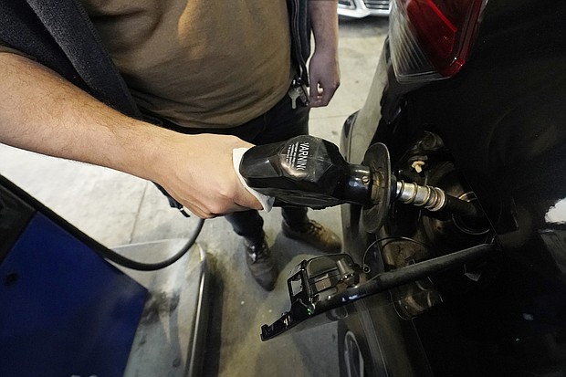 Predatory lenders are reportedly making money off rising gas and food prices, and pictured a customer pumps gasoline into his car at a Sam's Club fuel island in Gulfport, Miss., Feb. 19.
Mandatory Credit:	Rogelio V. Solis/AP