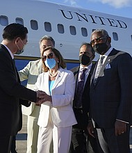 U.S. House Speaker Nancy Pelosi's Taiwan trip is another knock to China's yuan. In this photo, Taiwan's Foreign Minister Joseph Wu, left, speaks with Pelosi, center, as she prepares to leave in Taipei, Taiwan, on August 3.
Mandatory Credit:	AP