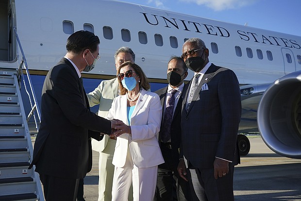 U.S. House Speaker Nancy Pelosi's Taiwan trip is another knock to China's yuan. In this photo, Taiwan's Foreign Minister Joseph Wu, left, speaks with Pelosi, center, as she prepares to leave in Taipei, Taiwan, on August 3.
Mandatory Credit:	AP