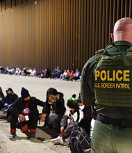 A US Border Patrol agent checks the passports of immigrants after they crossed the border with Mexico on May 18, in Yuma, Arizona. The ACLU alleges that agents in the Border Patrol's Yuma sector have been taking turbans from Sikh asylum-seekers.
Mandatory Credit:	Mario Tama/Getty Images