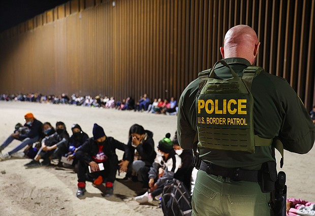 A US Border Patrol agent checks the passports of immigrants after they crossed the border with Mexico on May 18, in Yuma, Arizona. The ACLU alleges that agents in the Border Patrol's Yuma sector have been taking turbans from Sikh asylum-seekers.
Mandatory Credit:	Mario Tama/Getty Images