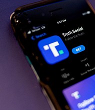 After facing a series of regulatory obstacles, the shell company attempting to take over former President Donald Trump's social media platform needs to extend a looming deadline to complete the controversial deal. A phone screen displays the Truth Social app in February.
Mandatory Credit:	Stefani Reynolds/AFP/Getty Images
