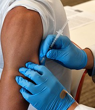 An analysis of monkeypox case records published by the US Centers for Disease Control and Prevention on August 5 offers new insight into the outbreak, which is disproportionately affecting men who have sex with men, especially those who are Black and Hispanic. A patient is seen receiving the vaccine on August 3 in California.
Mandatory Credit:	Richard Vogel/AP