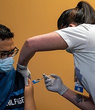 A healthcare worker administers a dose of the Pfizer-BioNTech Covid-19 vaccine in Peabody, Massachusetts on January 26. Data obtained by CNN from New York's largest health-care provider indicates you're very unlikely to become severely ill with Covid-19 if you're under age 60, up to date on your Covid-19 vaccines and don't have underlying health problems, backing up a government plan expected to be announced this week that will ease up on coronavirus restrictions.
Mandatory Credit: Vanessa Leroy/Bloomberg/Getty Images