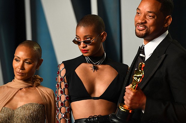 Willow Smith (center) is pictured with Will Smith and Jada Pinkett Smith. Willow Smith says she was not fazed by the media firestorm that broke out after her father, Will Smith, slapped Chris Rock at the 2022 Academy Awards, because she sees her "whole family as being human."
Mandatory Credit: Patrick T. Fallon/AFP/Getty Images