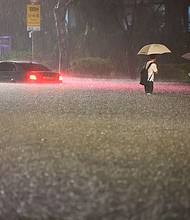 A vehicle is submerged in a flooded road in Seoul on August 8.
Mandatory Credit:	Hwang Kwang-mo/AP