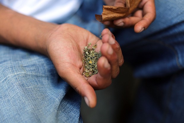 A man prepares to smoke K2 or "Spice," a synthetic marijuana drug, along a street in East Harlem on August 5, 2015, in New York City.
Mandatory Credit:	Spencer Platt/Getty Images