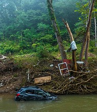 A vehicle is submerged in Troublesome Creek near Dwarf, Ky., on Thursday, Aug. 4, 2022. Flood waters devastated many communities in Eastern Kentucky last week.