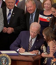 President Joe Biden signs the PACT Act into law at the White House on Wednesday - legislation aimed at expanding healthcare benefits for veterans and addressing exposure to toxic chemicals.
Mandatory Credit:	POOL