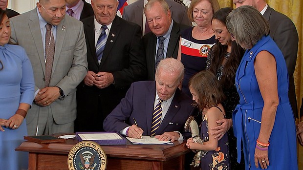 President Joe Biden signs the PACT Act into law at the White House on Wednesday - legislation aimed at expanding healthcare benefits for veterans and addressing exposure to toxic chemicals.
Mandatory Credit:	POOL