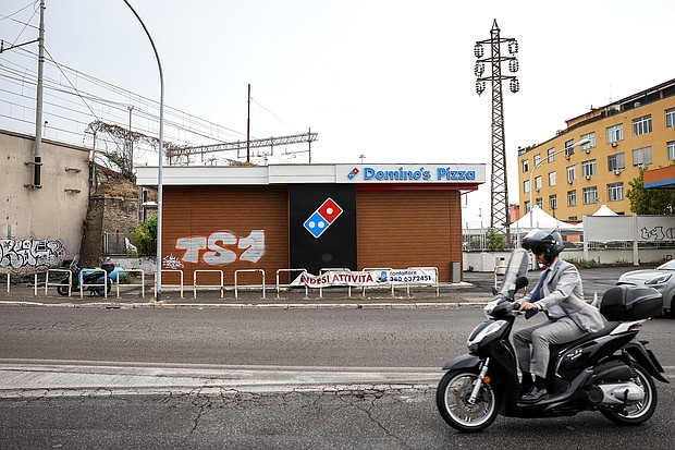 Seven years after its debut in Italy, Domino's has failed to sell pizza to the locals. A "For Sale" banner outside a closed-down Domino's Pizza Inc. store in Rome, Italy, is pictured here on August 9.
Mandatory Credit:	Alessia Pierdomenico/Bloomberg/Getty Images