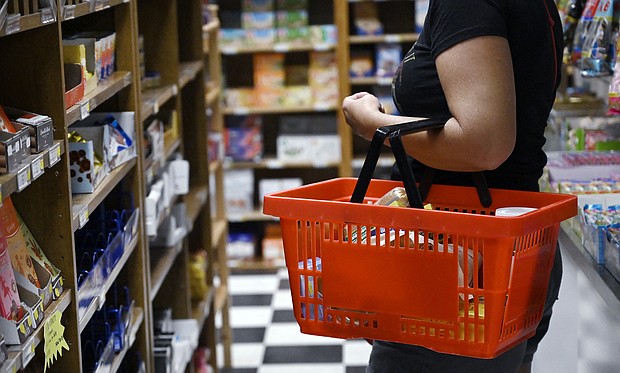 Runaway consumer prices took a breather in July. A woman shops for groceries on July 29 in Arlington, Virginia.
Mandatory Credit:	Olivier Douliery/AFP/Getty Images