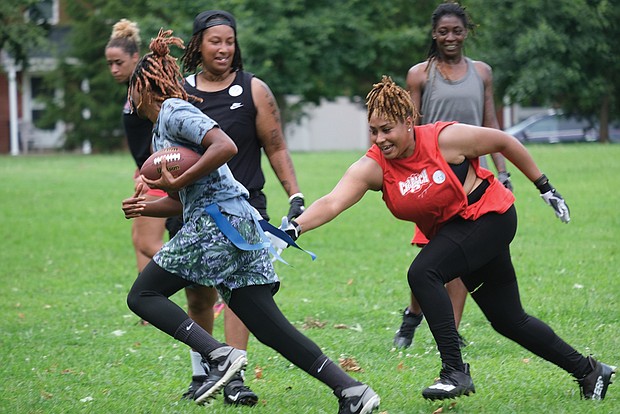 Jamesha Worthington grabs the flag from Tiana Fuller during open tryouts for the 804 Mafia Flag Football team at Randolph Community Center Park last Saturday. Owner Sha MaClin started the new team to help her Richmond Black Widows teammates stay in shape during the offseason.
