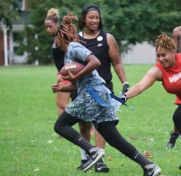 Jamesha Worthington grabs the flag from Tiana Fuller during open tryouts for the 804 Mafia Flag Football team at Randolph Community Center Park last Saturday. Owner Sha MaClin started the new team to help her Richmond Black Widows teammates stay in shape during the offseason.